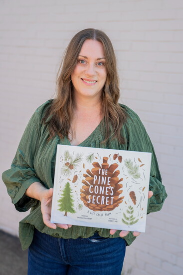 Hannah Barnaby with her book, "The Pine Cone's Secret." Photo Credit: Beth Kagarise