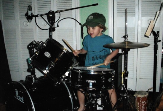 Liam playing drums at an early age