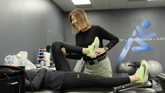 Clinical Manager Kim Parker, PTA, CLT, works with a client. 