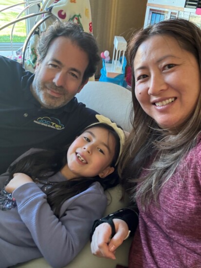 Joel relaxes with his wife Sienn and daughter Victoria, age 7.