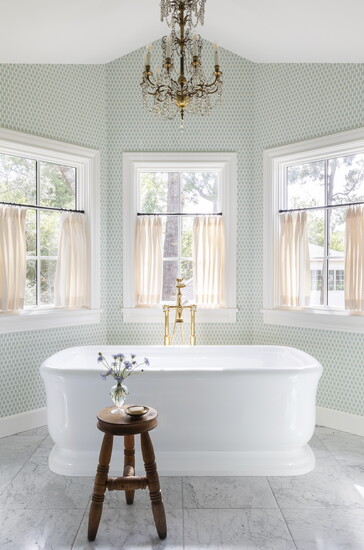 In this bathroom renovation, designer Emily Spanosused attic space tocreate avaulted ceiling.