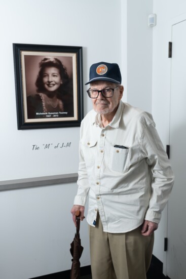 Owner John Toomey next to portrait of his late wife, Michelene, whom the "M" represents in J Bar M.