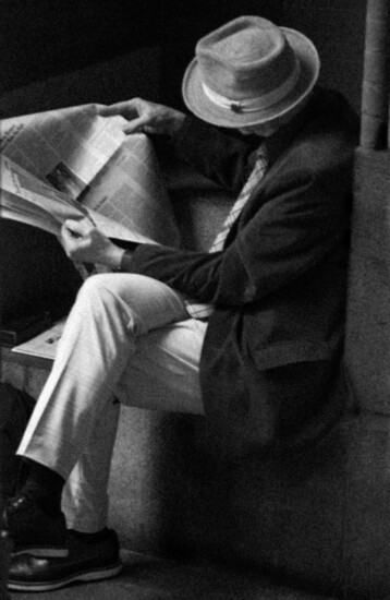 Man reading newspaper. Jay Cohen