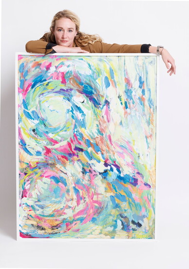 Artist Anna Sokol with one of her colorful paintings