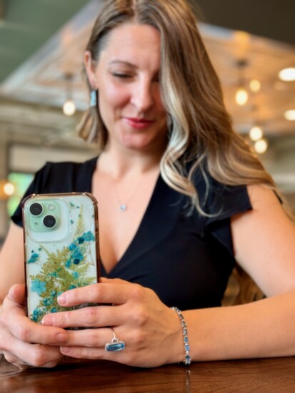 The blue topaz set harmonized perfectly with model Katelynn's handmade phone case, made from live greens and flowers