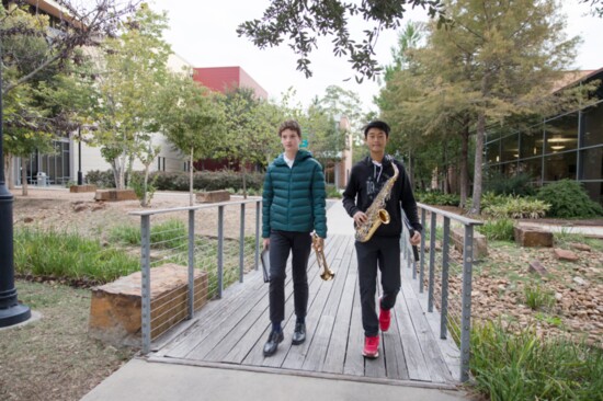 Two band students make their way across campus to perform.