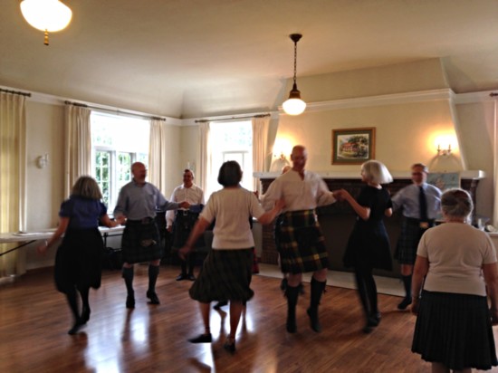 Visiting folk dancers show the club members how it’s done.