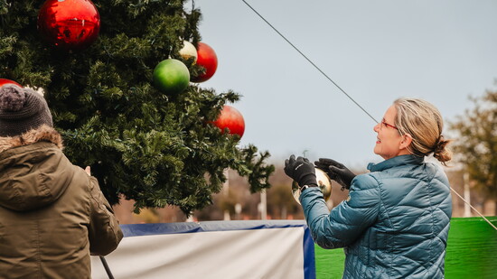 Volunteers taking down the Community Christmas Tree ornaments.