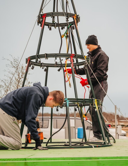 Volunteers chat as they deconstruct the Community Christmas Tree.