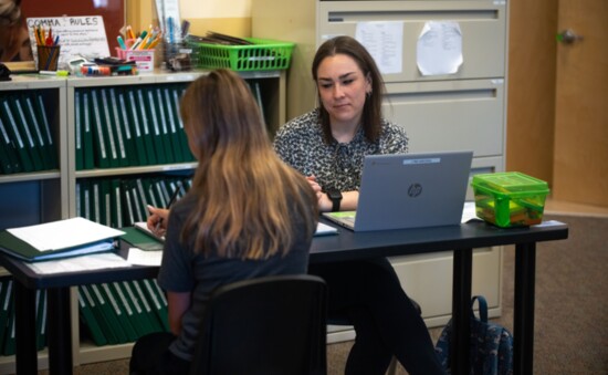 A tutor helps a student with her homework.