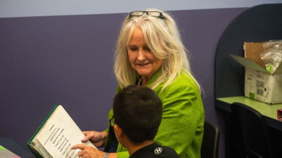 Maureen reads with a student at the learning center.