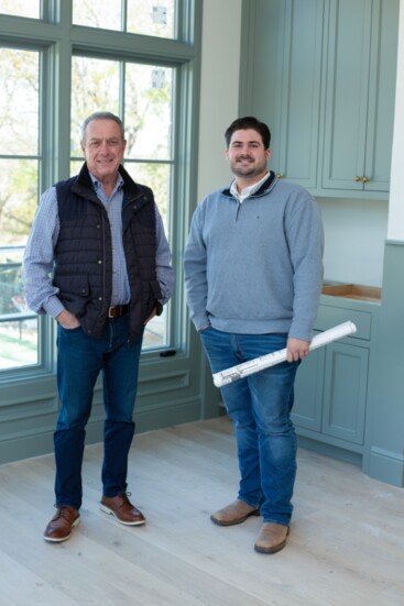 Nick and one of his associates review plans of a home being built.