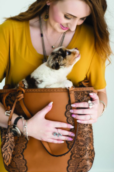 Jenna DeBow layers a cool watch with mixed-metal bracelets and cradles a furry surprise in this great Brighton bag.