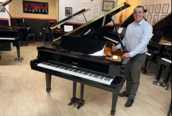 With a grand piano in his company's showroom, sales manager Tim Schaeffer represents the fourth generation of this family-owned business