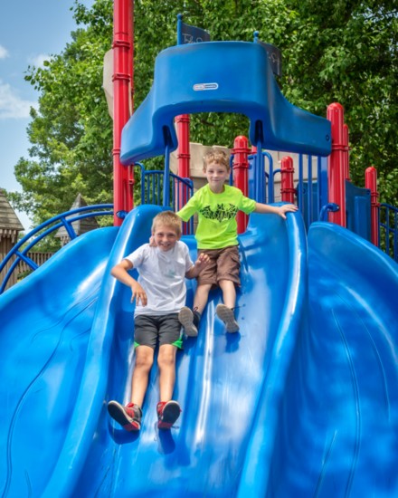 Brothers Ian and Robby Grant have fun on a slide at Kid's Kingdom in Hendersonville.