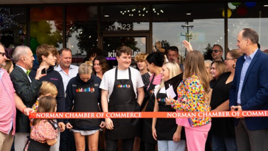 Ribbon cutting with Kidoodles owner Stephanie O'Hara (in pink), her family (husband Dirk in the bow tie), Kidoodles staff, Norman Chamber of Commerce staff and 