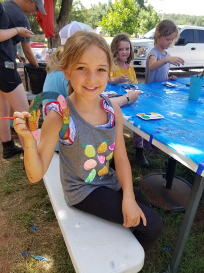 This camper holds her horseshoe craft project.