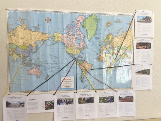 A map in Pete's workspace points to the various regions where he sources his hand-picked beans