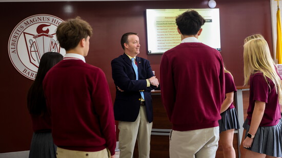 Joseph Tweed chatting with students at Albertus Magnus High School