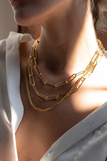 Layered necklaces can change the look of a simple white shirt.