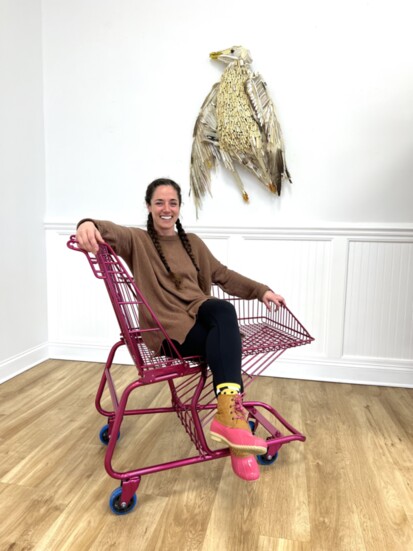 Maggie Fischer, Long Branch's Arts Director, kicks her feet up while relaxing in a chaise-style shopping cart chair designed by artist Roddy Wildeman.