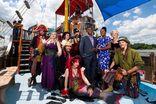 The Heberts pose with crew from their pirate ship.