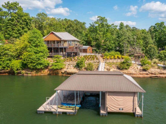 "Ducktail Pointe": Fun downstairs deck features outdoor TV, Edison lights and Crimson Tide CornHole game.