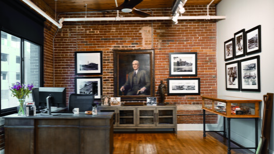 Designer Pebbles Glenn Nix chose a weathered gray finish for the desk and credenza to give a variety of textures to the office area. “The cases are a different