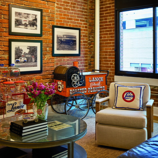 The club chairs, couch and round table came from Acquisitions Interiors in Atlanta. Pillows were custom made with embroidered Lance logos. The blue leather sofa