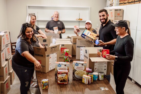 Arvada Lifestyle joins Lantern Home Group to pack meals for the Thanksgiving Food Drive.