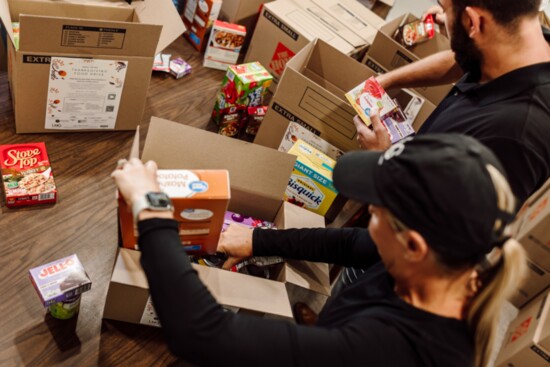 Assembling complete meal kits for families in need.