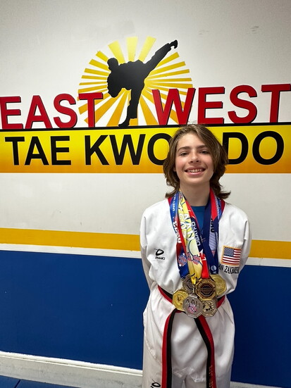 Ian as a Junior Black Belt winning more medals