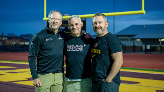 Dr. Rocci Trumper, Coach Chris Jones, and Athletic Director Eric Johnson share a moment on the Windsor Wizards’ field—united in supporting local athletes.