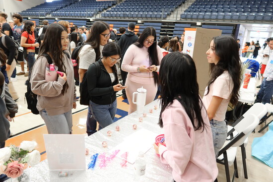 Katherine McClain and Natalia Acosta host a booth at the Volunteer Drive in order to educate area high schoolers about their nonprofit and ways to get involved.