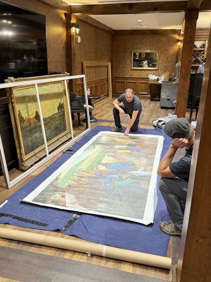 Lee and Matt prepare mural canvas painting for stretching. - Photo by Amy Tucker
