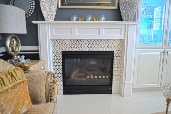 The remodel carried over into the living room, with the new flooring, hearth, mantel and glass-faced curio cabinet.