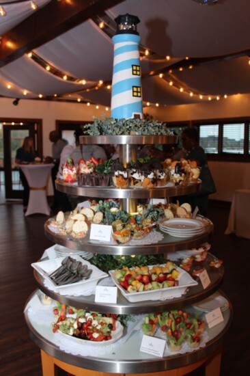 A lighthouse-themed food display offers tasty appetizers.