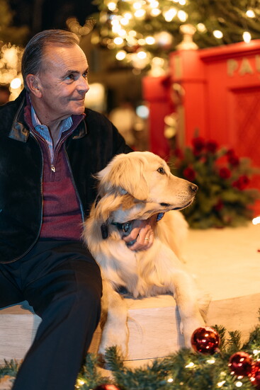 Rick Caruso and his dog Hudson at least year's Palisades Village tree lighting ceremony