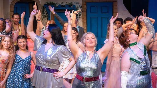 Careful choreography and costume design come together in this ensemble scene from Mamma Mia.