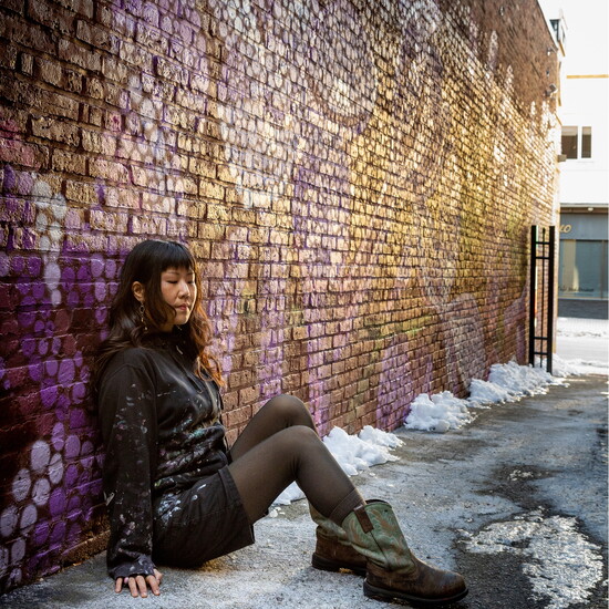 Marisa in front of her Lilac mural