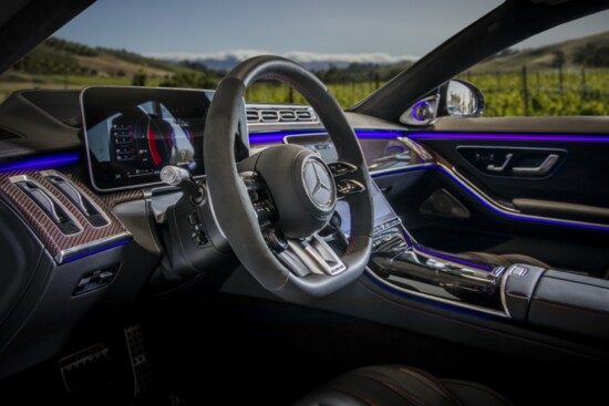 The AMG S63's cabin is opulent with distinctive carbon fiber dash, red contrast stitching, 12.8" OLED touch screen, Bermester sound system & blue moodlighting.