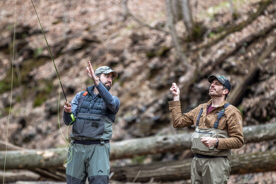 Andy Stiebler (right) gives Mike Nemeth a lesson in fly fishing.