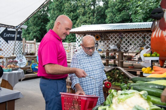 Steve Lamantini, left, helps a client with his shopping. 
