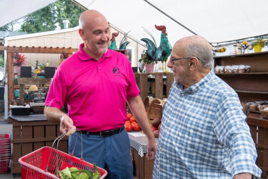 Steve LamSteve Lamantini, left, helps a client with his shopping. antini, left, runs Lion's Share Family Services