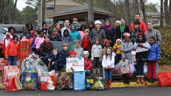 Little Helpers share gifts and holiday cheer with refugee families.