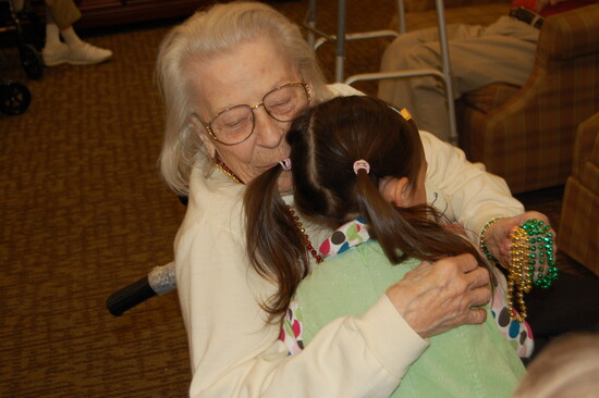 A favorite stop: visiting senior living homes and sharing hugs with residents.