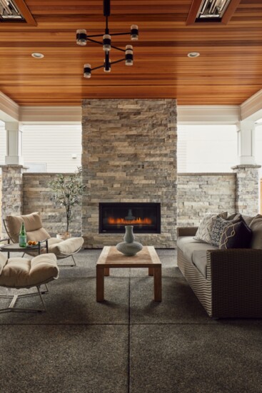 Bringing the living space outside for year round enjoyment. Full height stone fireplace and in ceiling heat. 