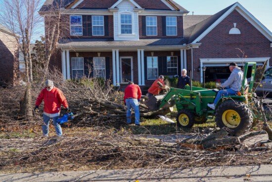 Volunteers work to clean up a home in Winston Hills following the Dec. 9 tornado.