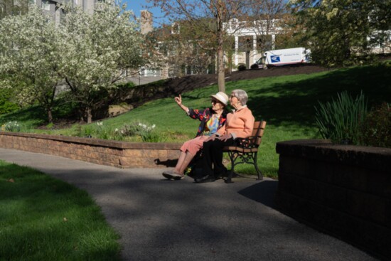 Residents at Wesley Glen enjoy an afternoon by the walking path.