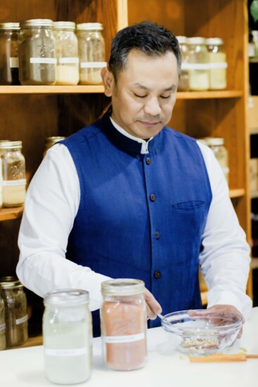 Ram Tamang prepares a customized herbal blend for a client.